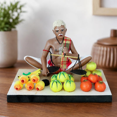 Niharika Collections Krishnanagar Handmade Clay Fruit Seller Idol, Sitting Human Figure Miniature,Hand-Painted Indian Art, Multicolour Home Décor,Golu Display & Gifting-15.2 x 10.2 x 10.2 cm