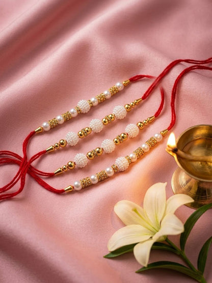 Anouk Set Of 4 White Pearls & Red Thread Rakhi With Roli Chawal Chandan Mishri