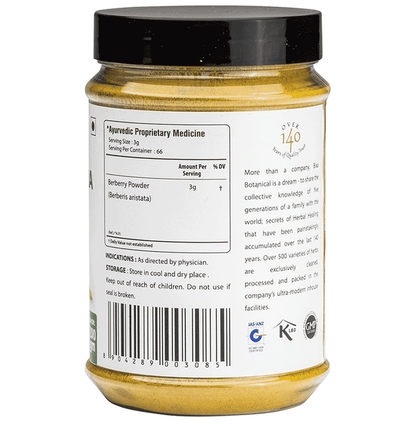 Bixa Botanical Daruharidra powder in a clear glass bowl, displaying vibrant yellowish-brown Ayurvedic herbal powder.