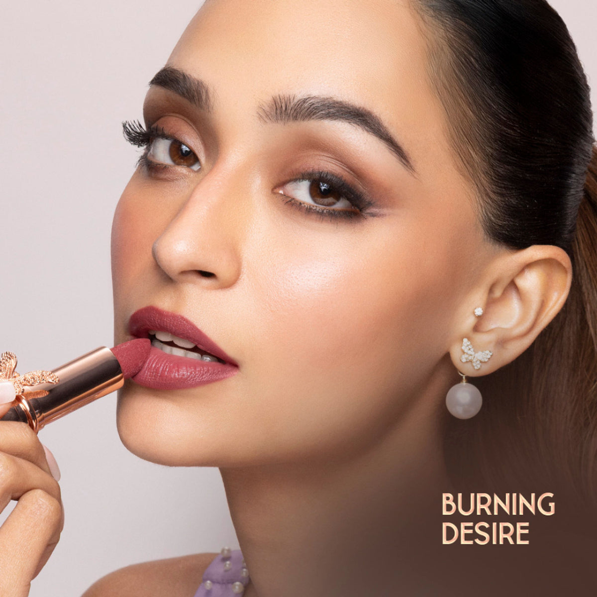 Nykaa Cosmetics Bridgerton creamy matte longwear lipstick in Burning Desire, deep red shade, with a smooth, velvety finish.