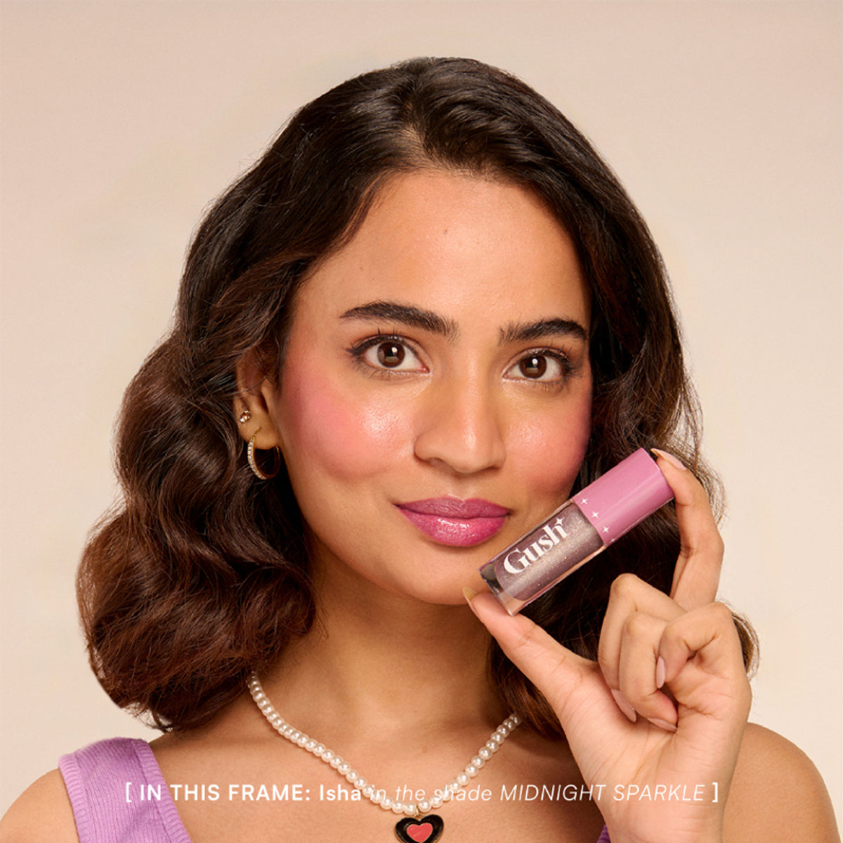 Gush Beauty pH-Inched Transformative Glossy Lip Tint in Midnight Sparkle, showing a shimmering dark lipstick on lips.