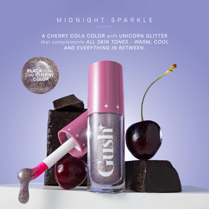 Gush Beauty pH-Inched Transformative Glossy Lip Tint in Midnight Sparkle, showing the shimmering, deep hue on lips.