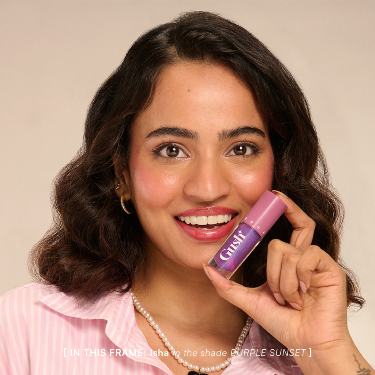 Gush Beauty pH-Inched Transformative Glossy Lip Tint in Purple Sunset, showing a vibrant purple lip gloss on lips.
