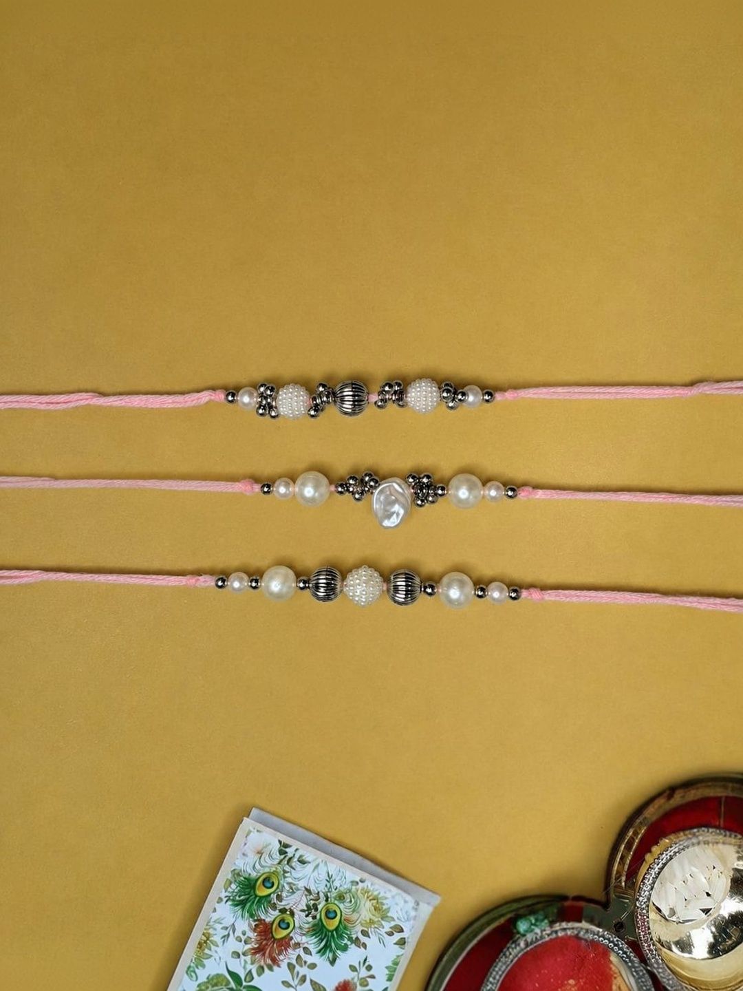 Anouk Set Of 3 White Pearls Thread Rakhi With Roli Chawal Chandan Mishri