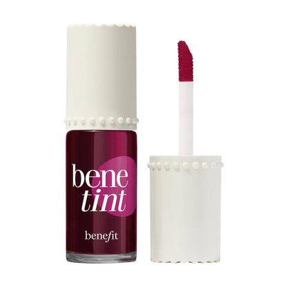 Benefit Cosmetics Benetint lip and cheek tint in raspberry shade, featuring a clear glass bottle with a brush applicator.