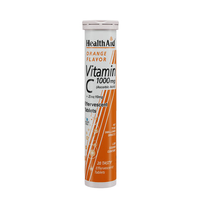 HealthAid Vitamin C 1000mg orange flavor effervescent Ayurvedic tablets with zinc, shown in a glass of dissolved tablets.