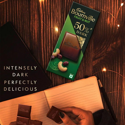 Cadbury Bournville fruit and nut dark chocolate bar with visible pieces of dried fruit and nuts in the smooth dark chocolate.