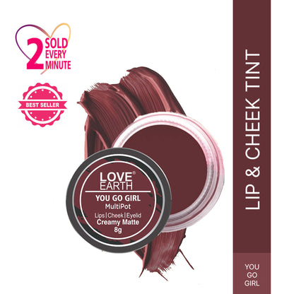Love Earth You Go Girl multipot lip and cheek tint in a compact container, showing the vibrant color and product label.