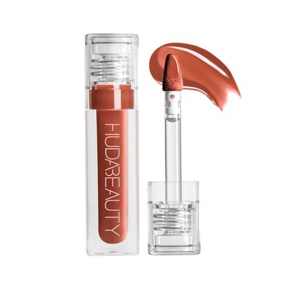 Huda Beauty FAUX FILLER Extra Shine Lip Gloss in Foxy, featuring a glossy finish and smooth applicator on a neutral background