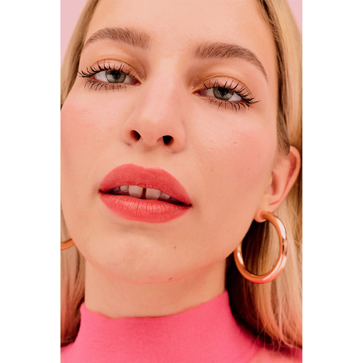 Benefit Cosmetics Plushtint Matte Lip Tint in Fuzzy Slippers Strawberry Red, showing the tube and applicator of this vibrant lip color.