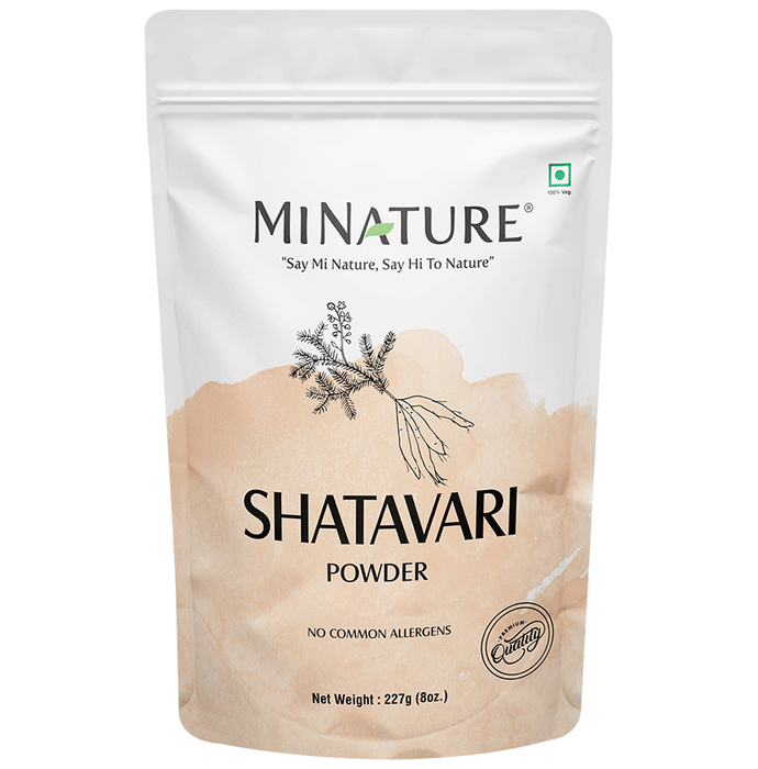 Organic Minature Shatavari powder in a glass jar, Ayurvedic herbal supplement for women, with fresh dried roots visible.