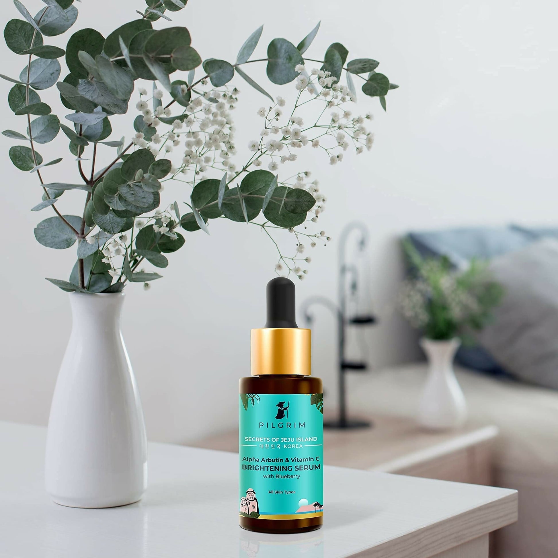 Pilgrim brightening face serum with 2% alpha arbutin and 3% vitamin C for glowing skin, in a clear glass bottle with dropper.