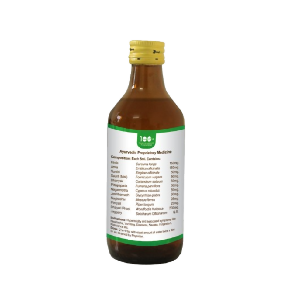 Bottle of Pathak Ayurvedic Pharmacy Pittamla Kadha Ayurvedic syrup with herbal ingredients in a glass bottle on a wooden table