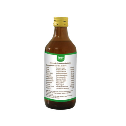 Bottle of Pathak Ayurvedic Pharmacy Pittamla Kadha Ayurvedic syrup with herbal ingredients in a glass bottle on a wooden table