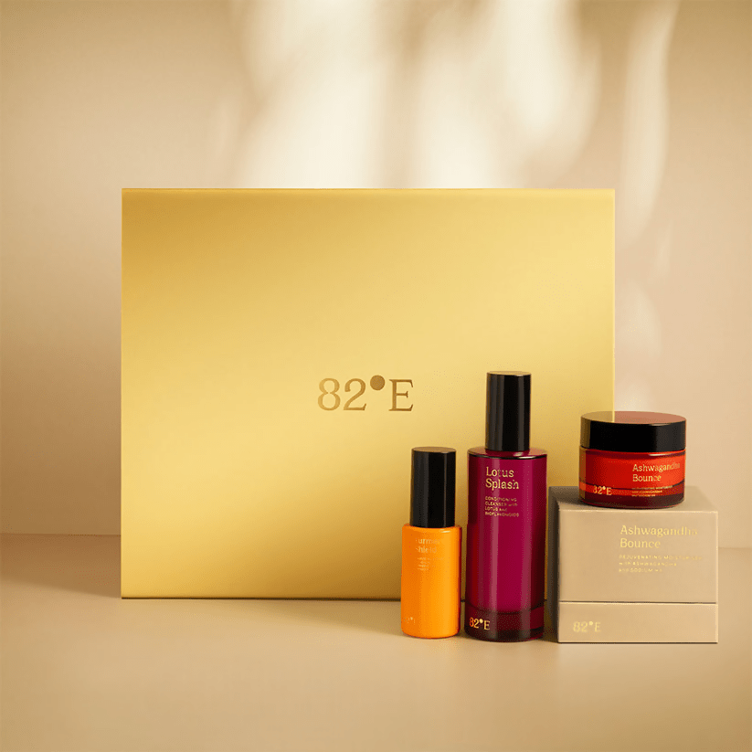 82°E by Deepika Padukone skincare gift kit with gold packaging featuring mini sunscreen bottles and skincare products.