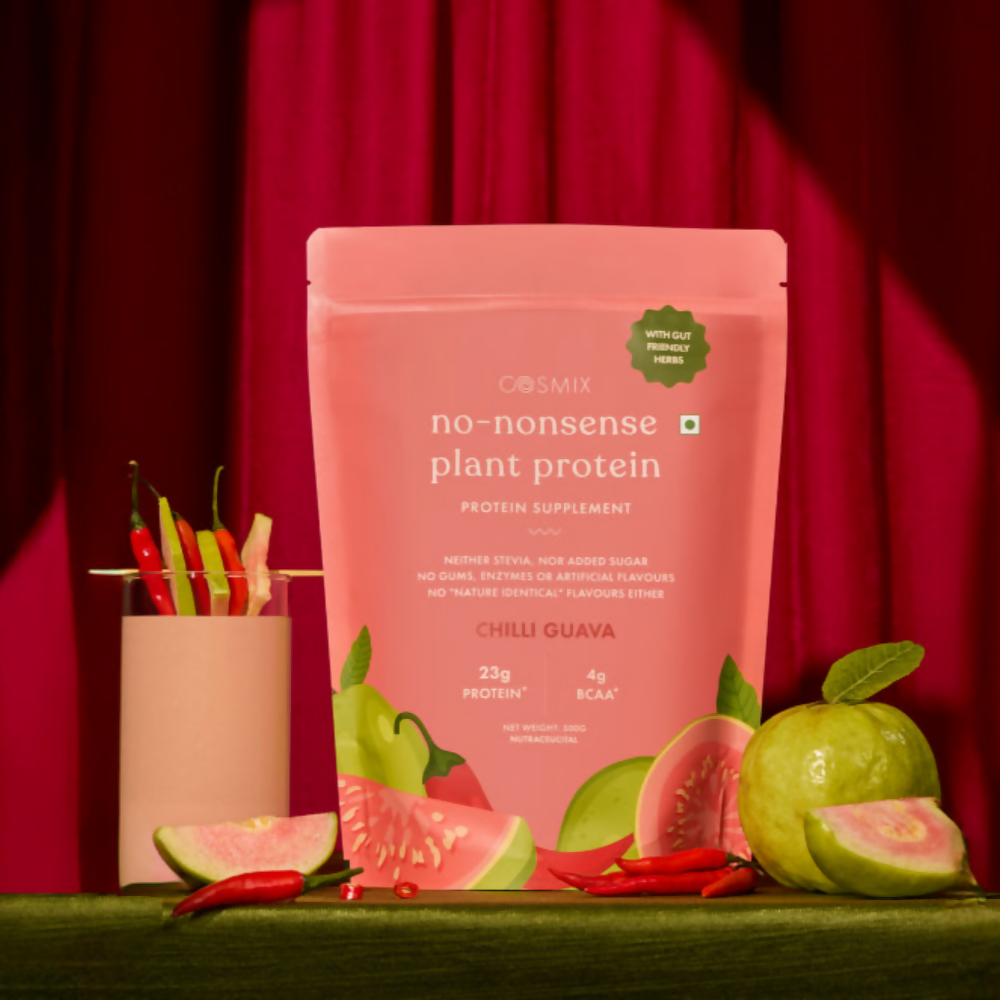 Cosmix No Nonsense Plant Protein Chilli Guava health drink in a clear glass with vibrant red and green colors, fresh fruit slices visible.