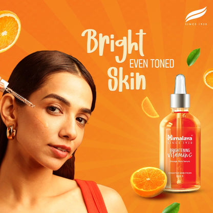 Himalaya Brightening Vitamin C Orange Face Serum with 5x Vitamin C and hyaluronic acid, showcasing the serum bottle and orange extract.