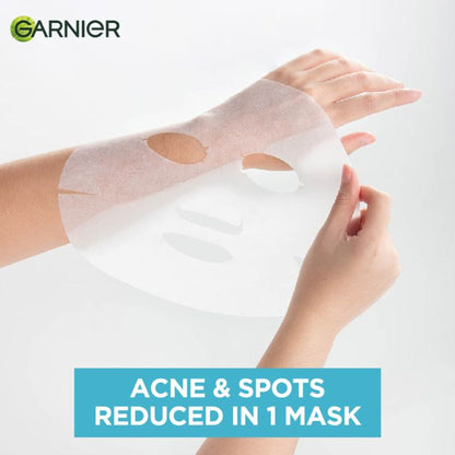 Garnier Bright Complete anti-pimple sheet mask with salicylic acid, niacinamide, and vitamin C serum on skin.