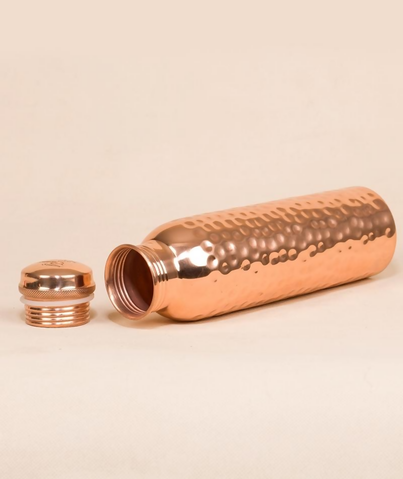 Hammered copper water bottle by Isha Life, 950 ml capacity, featuring a textured finish and traditional design.