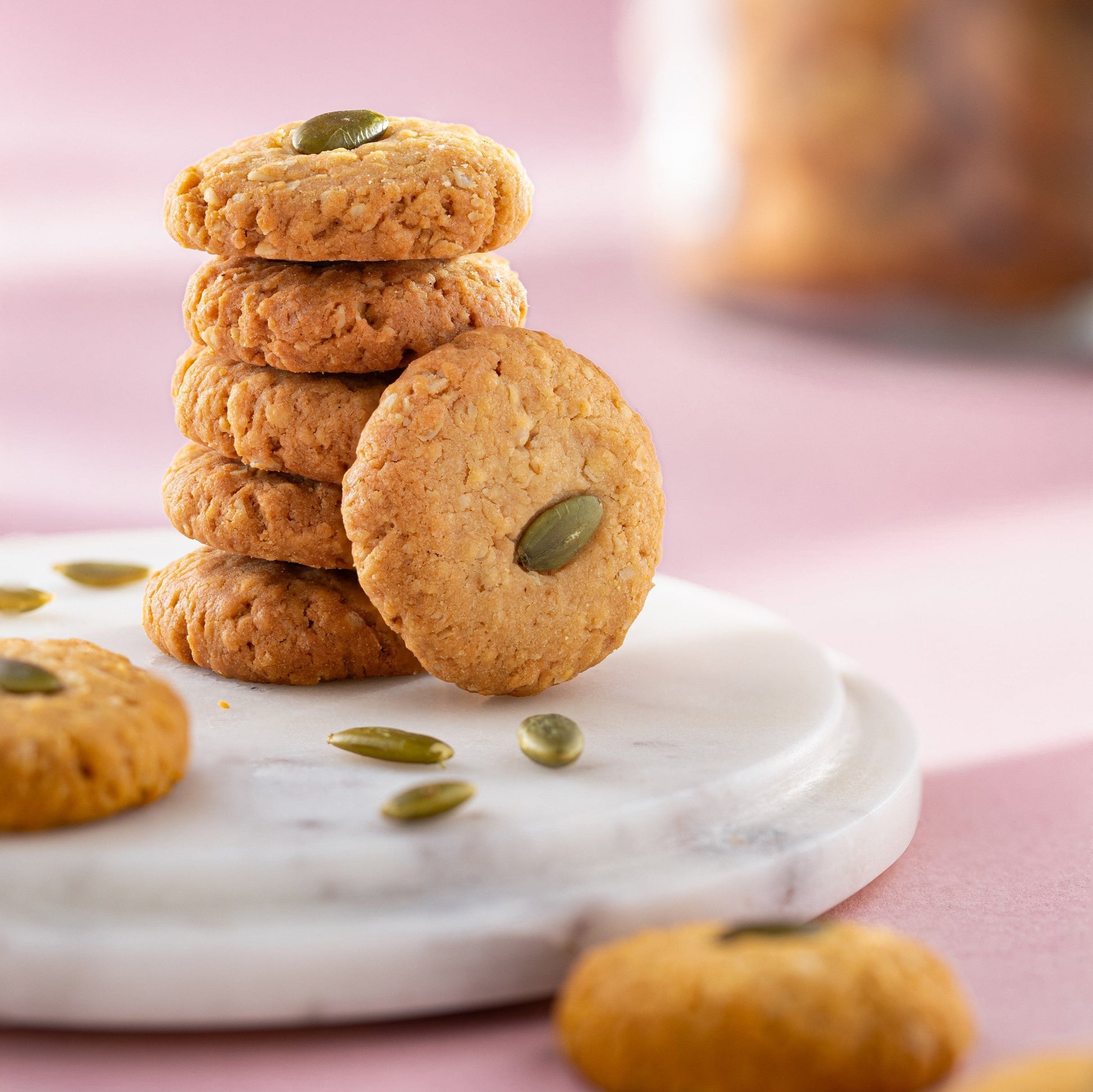 Almond House oats jaggery cookies jar with biscuits visible inside, showcasing the healthy, crunchy oat and jaggery flavored cookies.