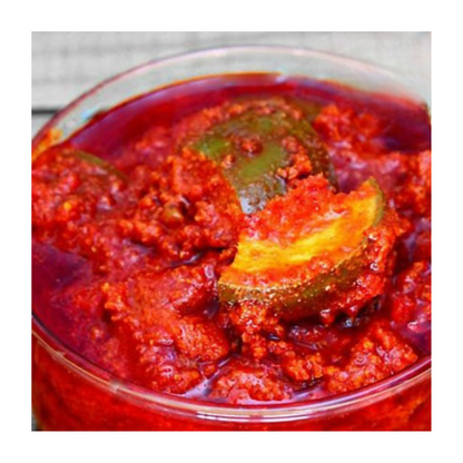 North Indian mango pickle by 21Pickles, showcasing vibrant orange color and chunky texture in a glass jar.
