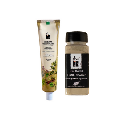 Isha Life herbal tooth powder and toothpaste combo in a natural, eco-friendly packaging with herbal ingredients visible.