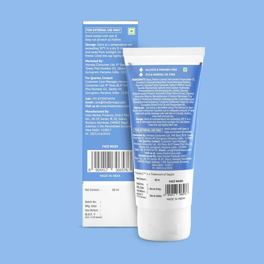 The Derma Co Sali-Cinamide Anti-Acne Face Wash in a clear pump bottle with white and blue packaging and product label visible.