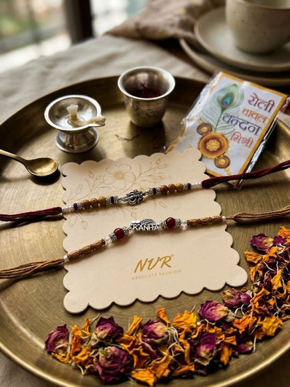Anouk Set Of 2 Silver Toned Religious Rakhi Thread Rakhi Roli Chawal Chandan Mishri