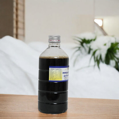 Impcoops Draksharishta No.I Ayurvedic herbal syrup in a glass bottle with a label and measuring cup, on a white background.