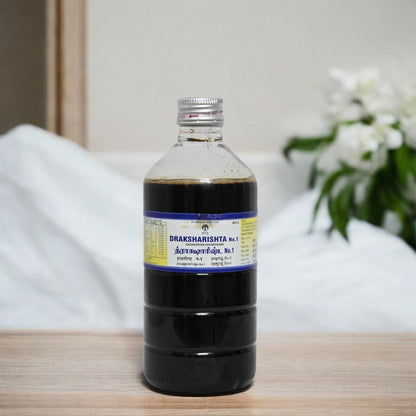 ImpCops Draksharishta No.I Ayurvedic herbal tonic in a glass bottle with a traditional label.