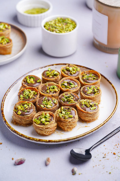 Gourmet Baklava Nutella Nest North Indian sweet with layered pastry and Nutella filling, served on a white plate.