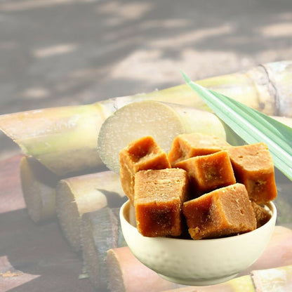 Naivedyam chemical-free jaggery cubes, natural brown sugar blocks for cooking and sweetening, displayed on a wooden surface.