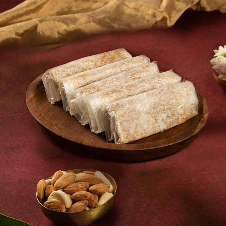Dry fruit Pootharekulu sweets from Almond House, thin crispy Indian dessert filled with dry fruits and jaggery.