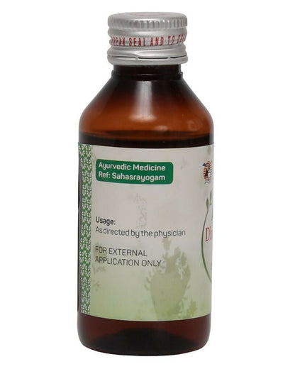 Amrita Dhanwantaram Ayurvedic Thailam in a glass bottle with dropper, traditional herbal oil for holistic wellness.