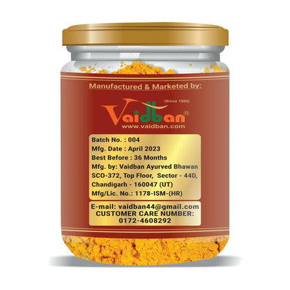 Vaidban Organic Pancham Haldi powder in a glass jar, showcasing vibrant yellow turmeric powder in an Ayurvedic herbal supplement container.