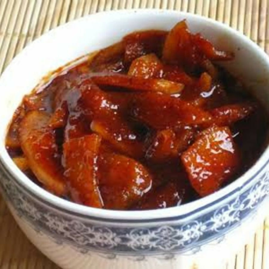 Konaseema Sweet Mango Pickle (Bellam Avakaya) in a jar, showcasing vibrant mango pieces and traditional North Indian pickle style.