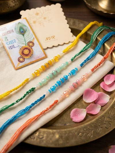 Indyancart Set Of 4 Multicolor Artificial Beads Thread Rakhi With Roli Chawal Chandan Mishri