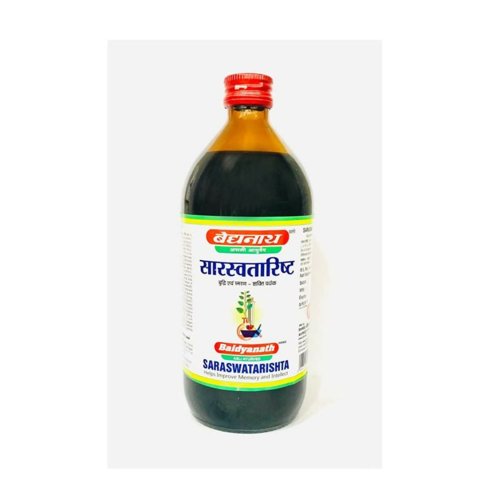 Baidyanath Jhansi Saraswatarishta Ayurvedic syrup bottle with label and pouring cap, placed on a wooden surface.