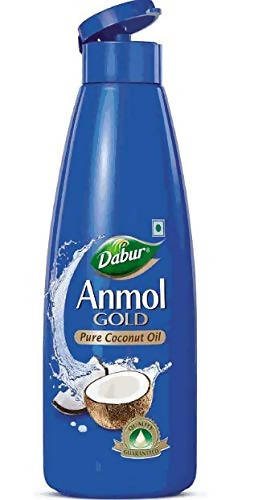 Dabur Anmol Gold pure coconut oil bottle for hair care, showcasing the product in a clear container with a gold label.