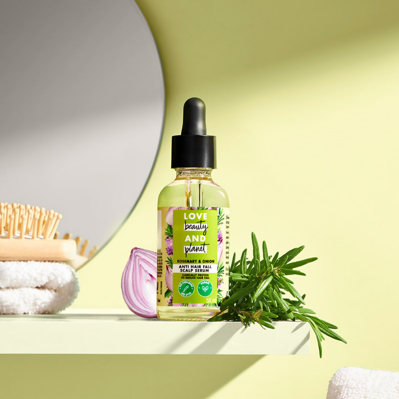 Love Beauty and Planet Onion & Rosemary anti-hair fall scalp serum in a clear bottle with a pump dispenser, showing fresh rosemary sprigs