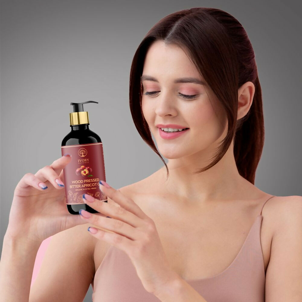 Ivory Natural organic pressed bitter apricot oil in a glass bottle, ideal for deep hair moisturization and gentle hydration.