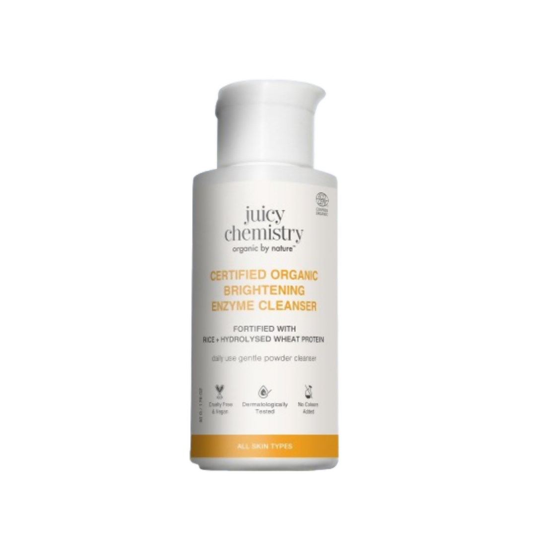 Juicy Chemistry Certified Organic Brightening Enzyme Cleanser in a white bottle with a pump dispenser, featuring natural ingredient illustrations.