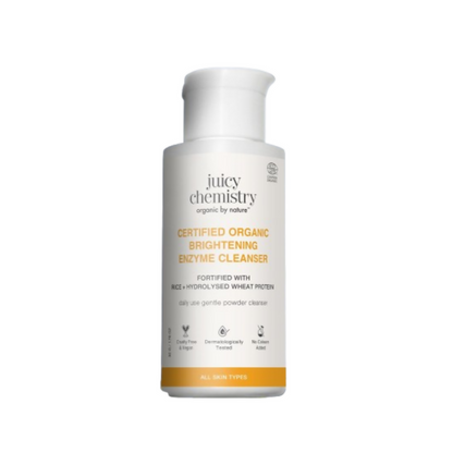 Juicy Chemistry Certified Organic Brightening Enzyme Cleanser in a white bottle with a pump dispenser, featuring natural ingredient illustrations.
