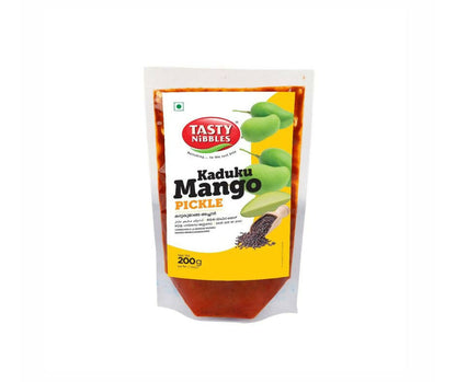 Tasty Nibbles Kaduku Mango Pickle in a jar, showcasing vibrant yellow-orange mango pieces and spices, North Indian style.