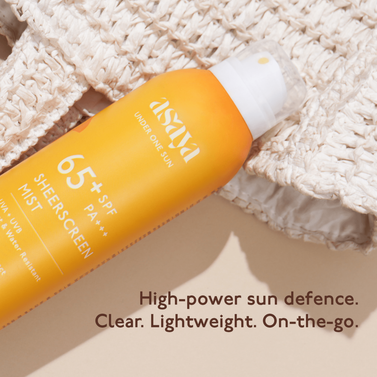 Asaya Broad Spectrum SPF 50+ waterproof sunscreen spray for face and body, shown in a clear spray bottle with label.