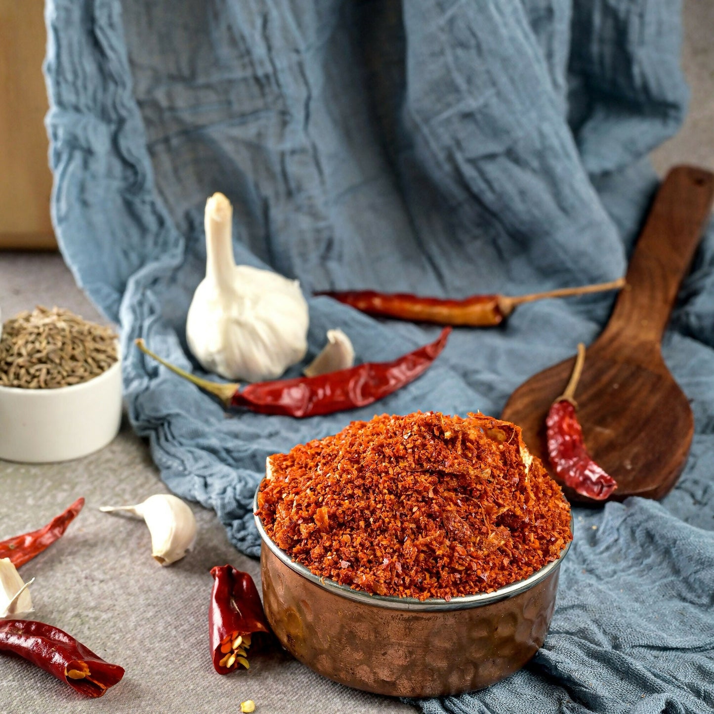 Vellanki Foods Iguru Karam chili powder in a jar, vibrant red spice used for flavorful Indian dishes.
