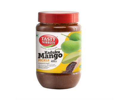 Tasty Nibbles Kaduku Mango Pickle in a jar, North Indian style, showing bright orange mango pieces and spices