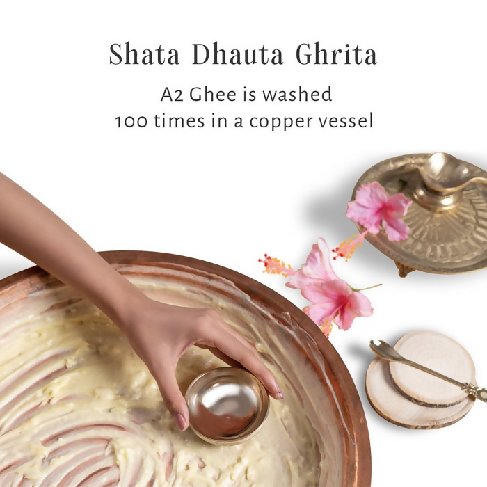 Shankara by Sri Sri Tattva Gheesutra Face Emulsion cream in a white jar with a gold lid, showcasing the product label on the container.