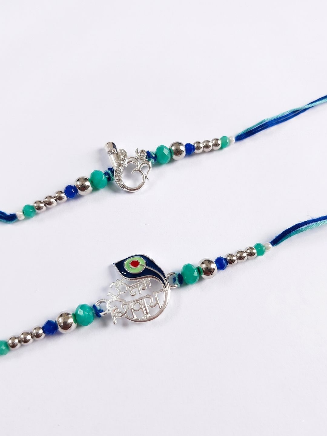 Anouk Set Of 2 Silver Toned Beaded Religious Thread Rakhi With Roli Chawal Chandan Mishri