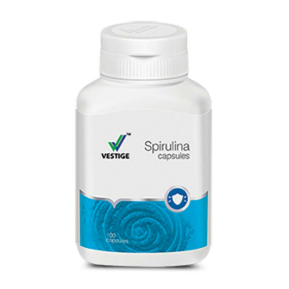 Vestige Spirulina capsules in a bottle, Ayurvedic supplement with green spirulina powder capsules for health and wellness.